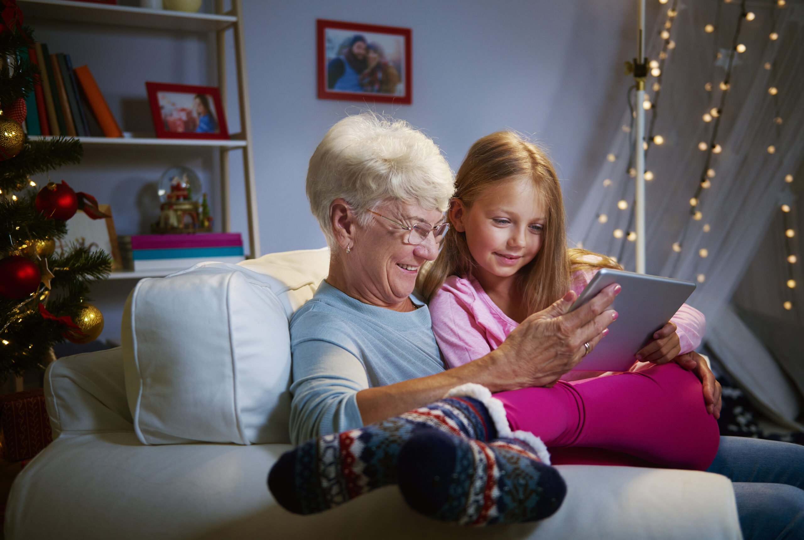 Grandmother and granddaughter reading together